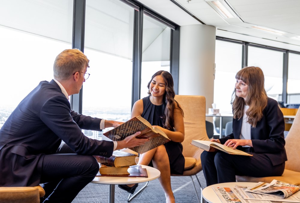 Herbert Smith Freehills Graduate - Young female professional having a meeting with colleagues.