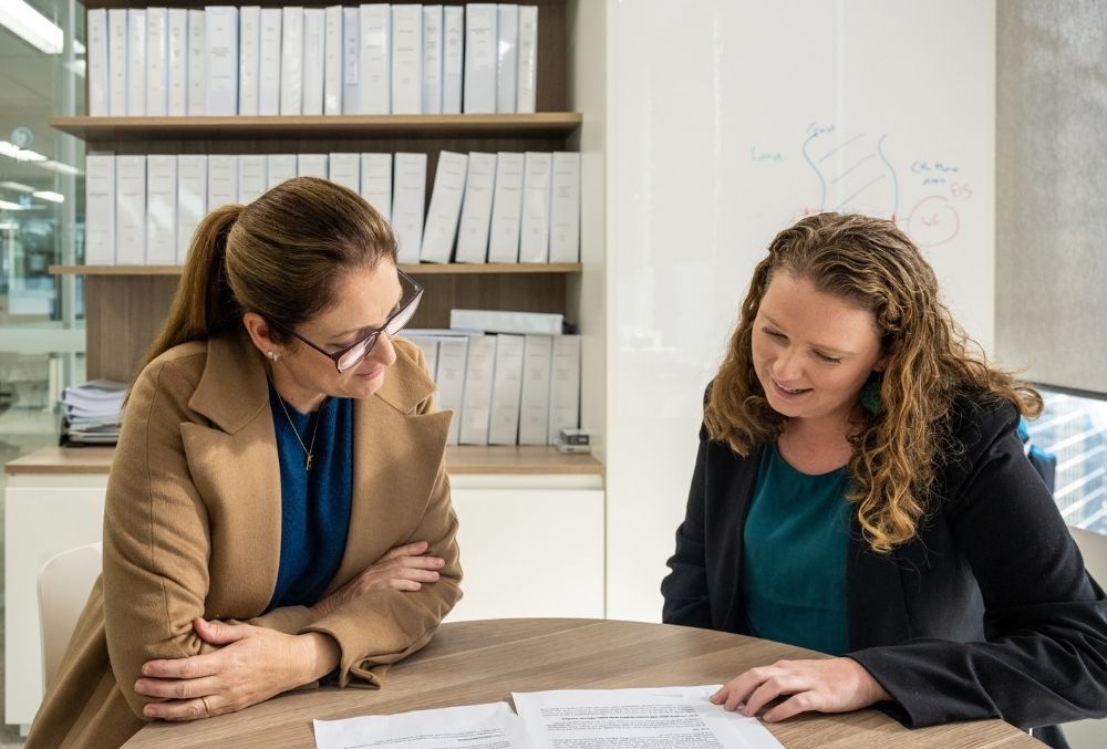 white & case Mikaylie talking with colleague 