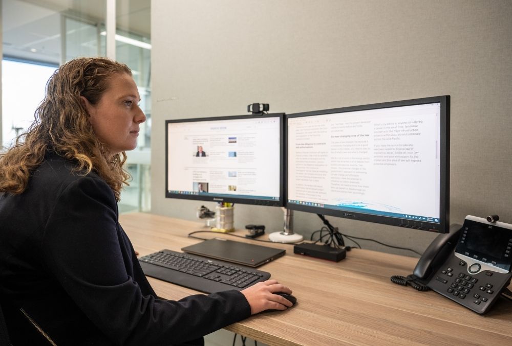 white & case Mikaylie working on her desk