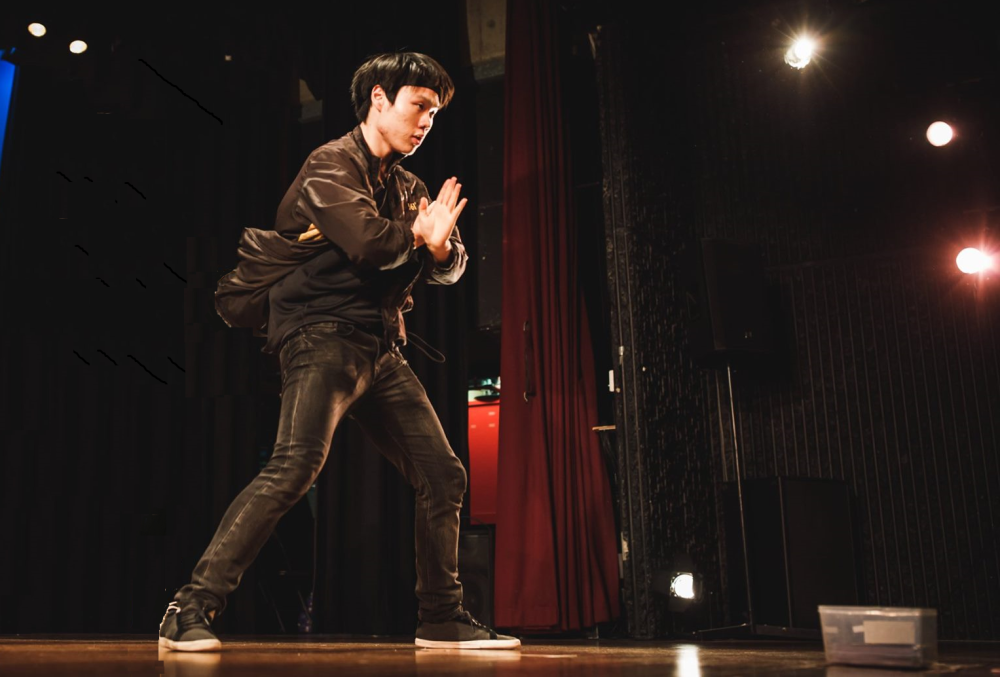 Male graduate rehearsing for his upcoming stage performance after work